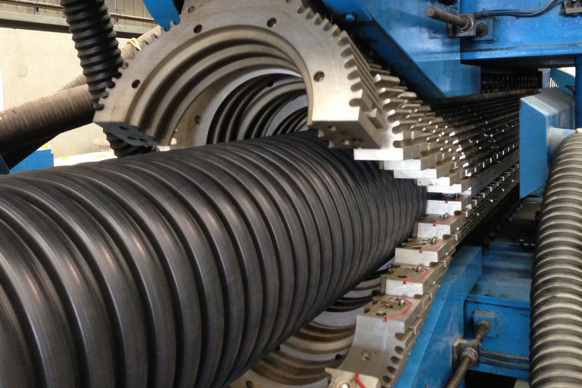 Production of a Bailey Bazooka culvert pipe coming out of extruder machine